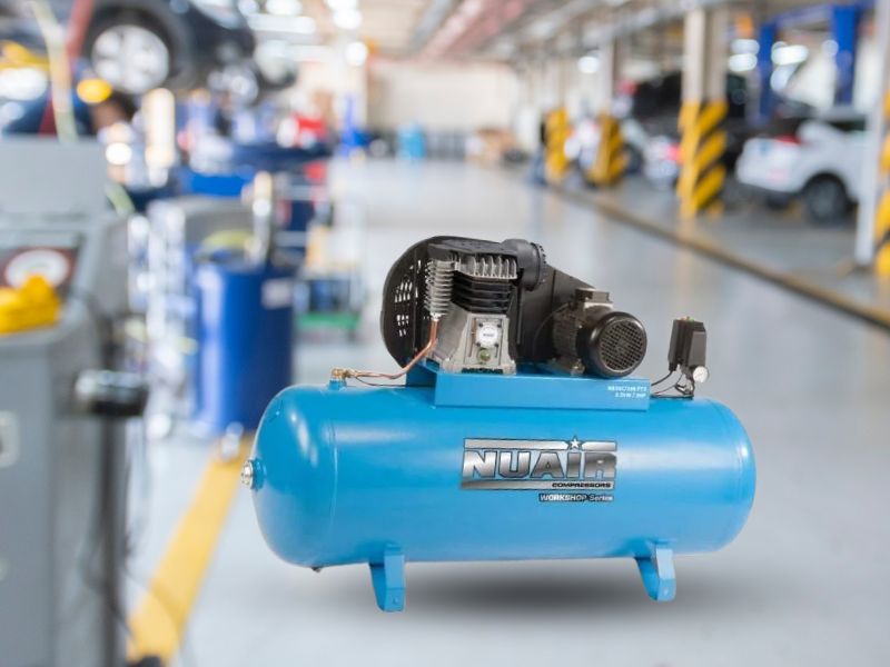 Nuair blue belt drive air compressor inside a garage environment